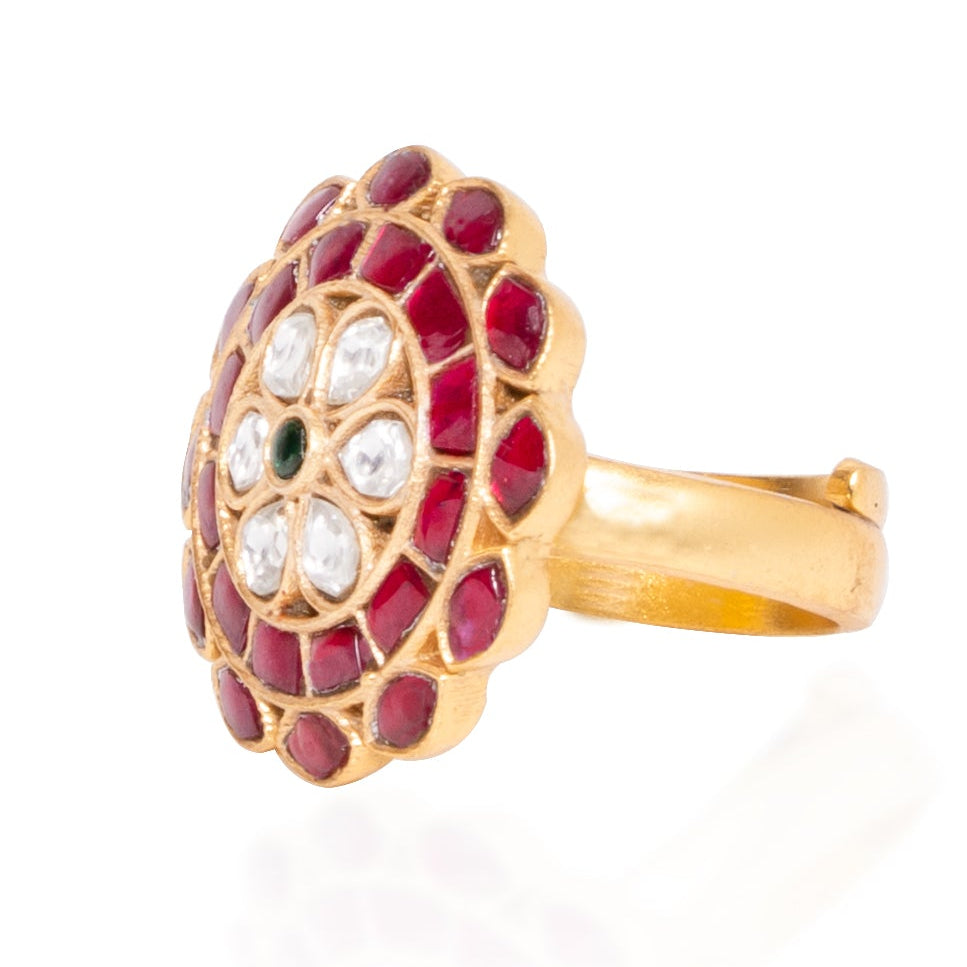 Gold ring with red gemstones on a white background