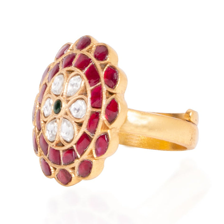 Gold ring with red gemstones and white stones on a white background