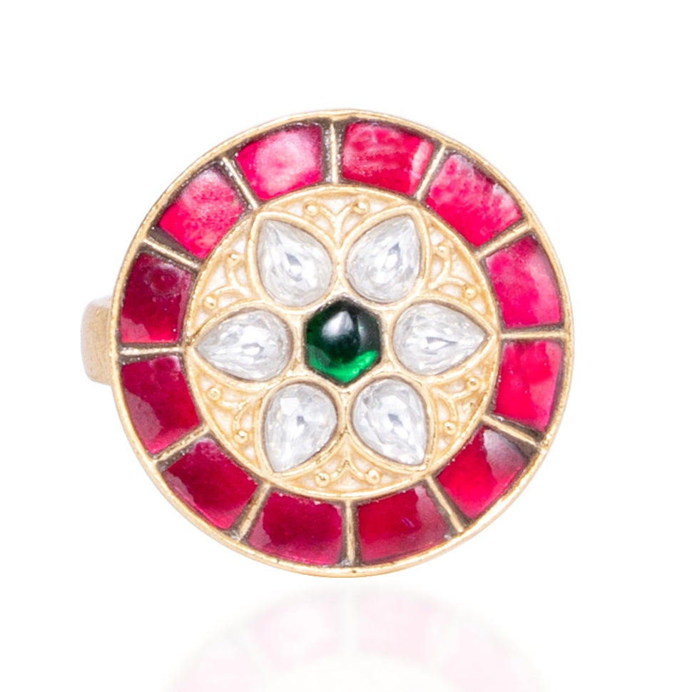 Round gemstone ring with red and white stones on a white background