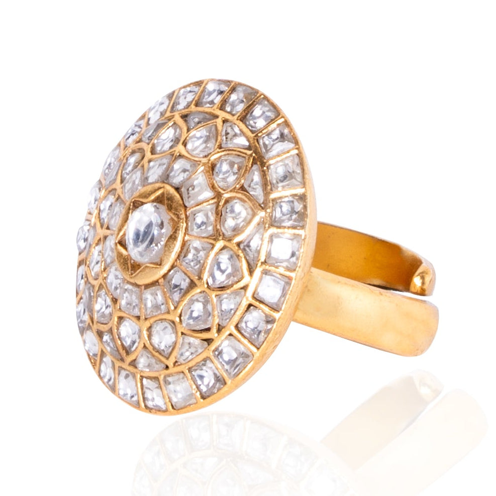 Gold ring with diamond-studded design on a white background