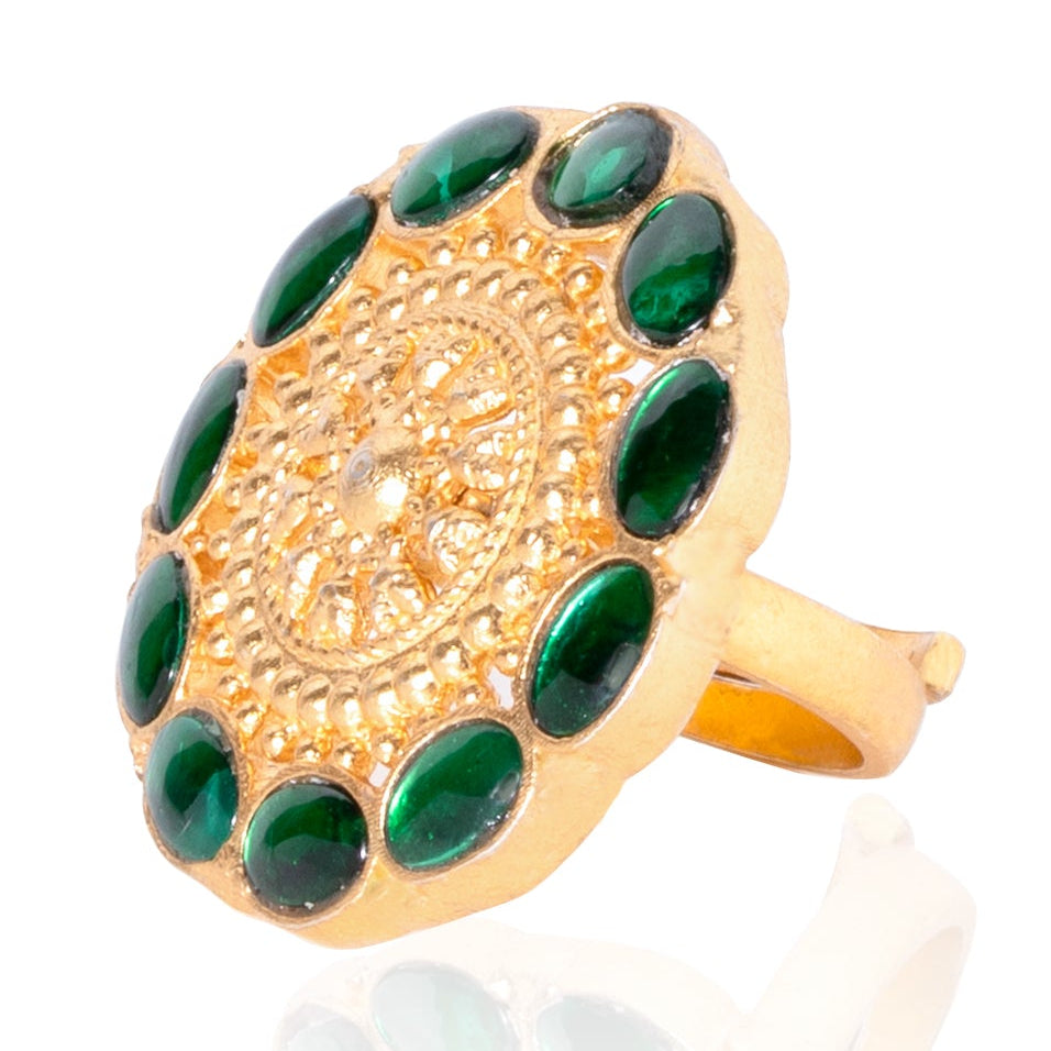 Gold ring with green gemstones on a white background