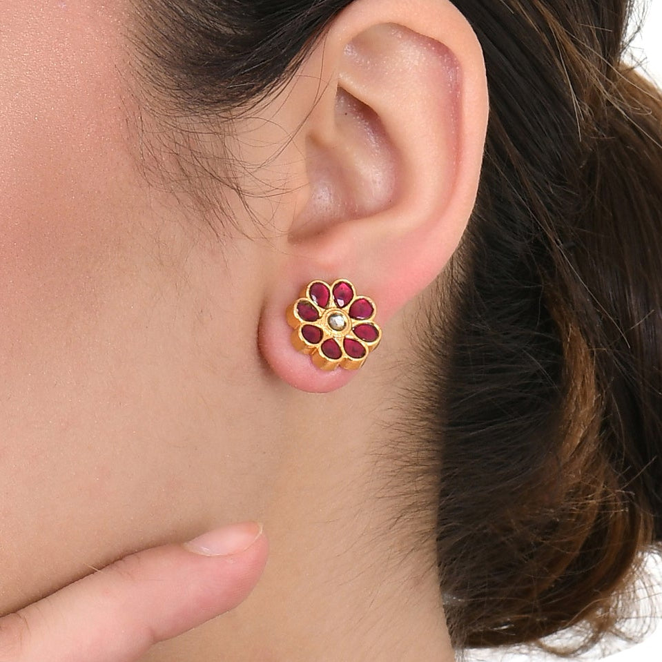 Woman wearing a floral earring on a white background