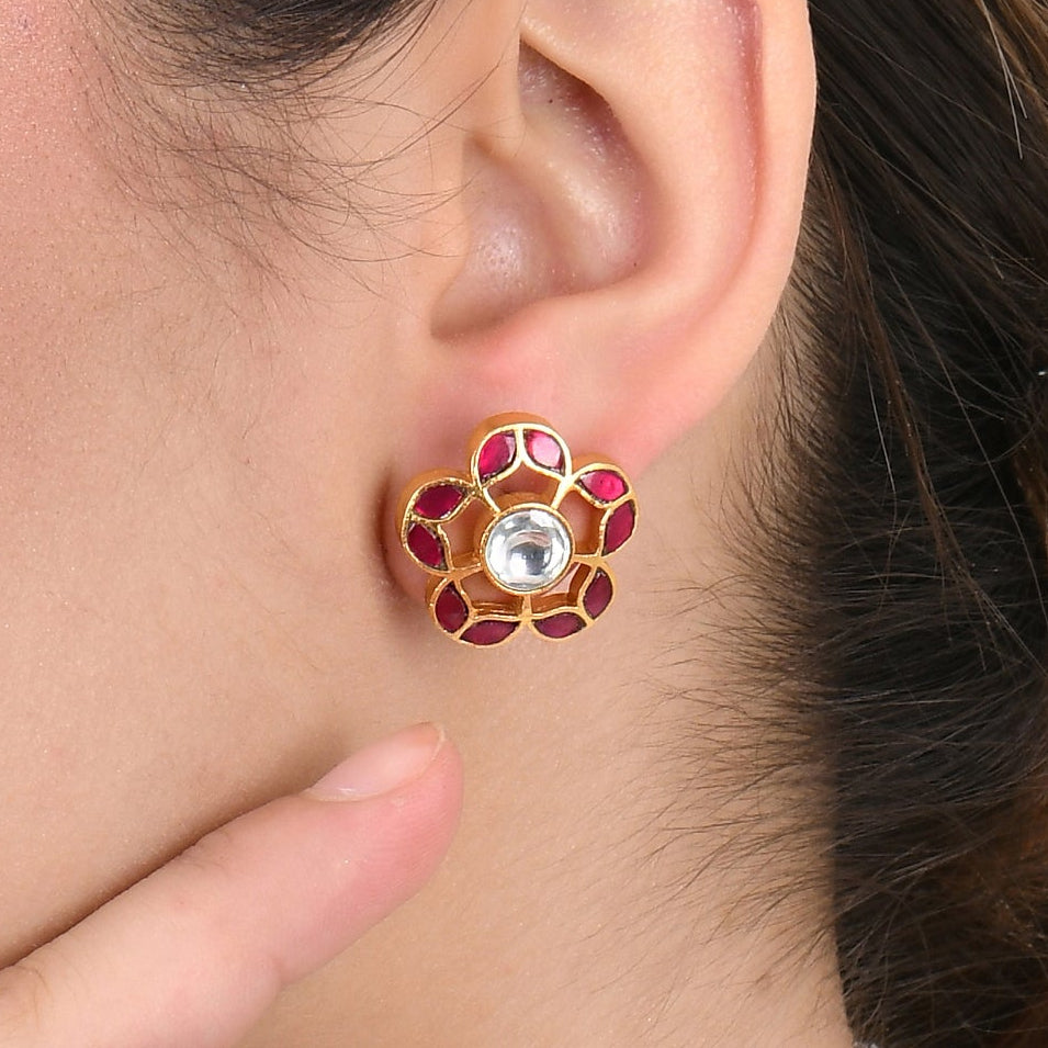 Woman wearing a floral earring on a white background