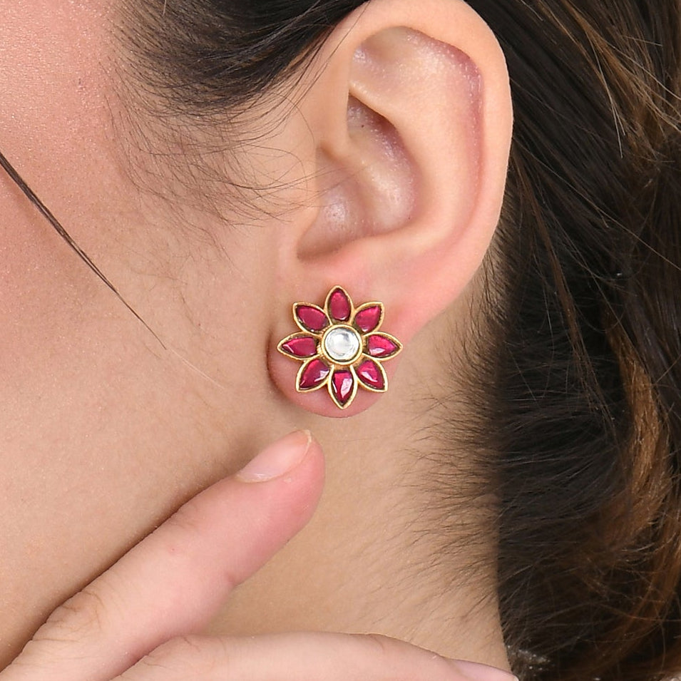 Woman wearing a floral earring on a white background