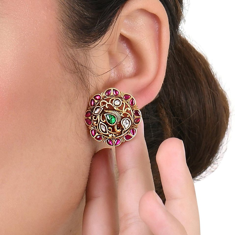 red stone gold earring on women ear