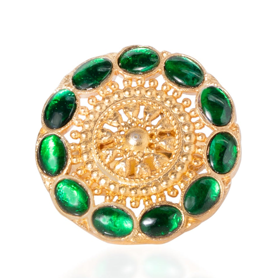 Gold brooch with green gemstones on a white background