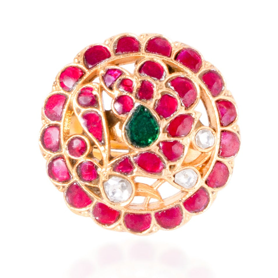 Jewelry item with pink stones and a green gem on a white background