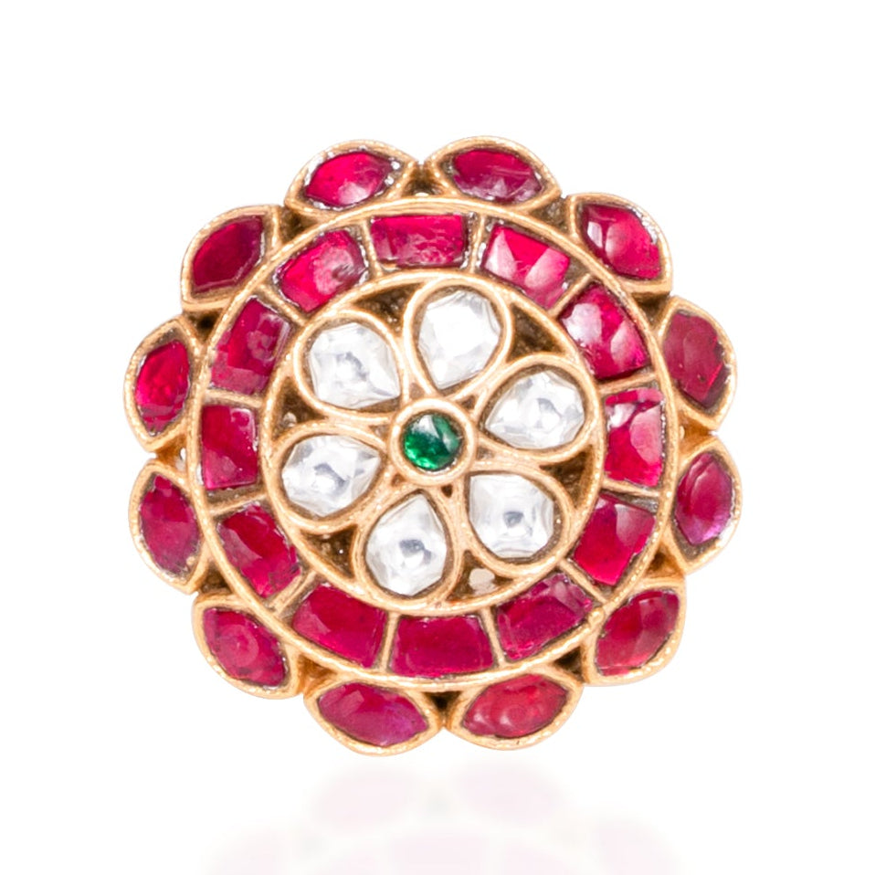 Jewelry item with red gemstones and gold accents on a white background