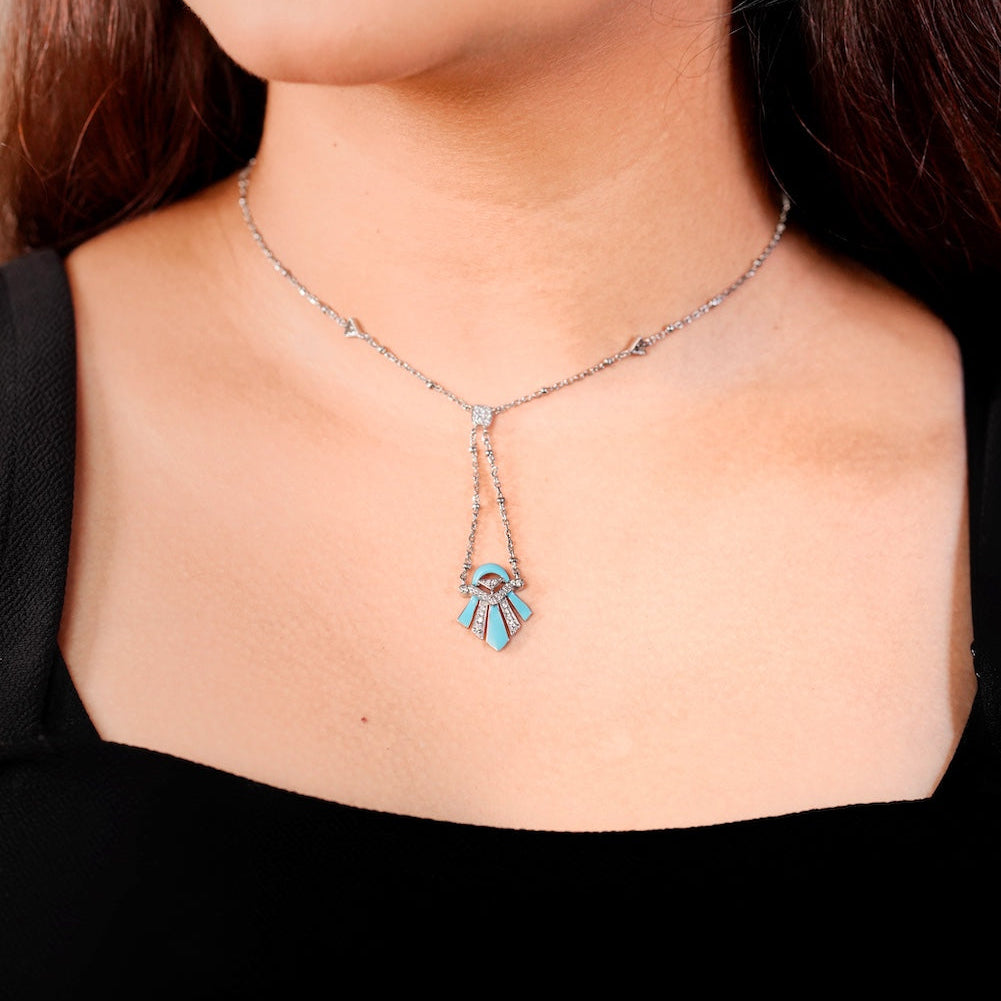 Close-up of a woman wearing a necklace with a pendant