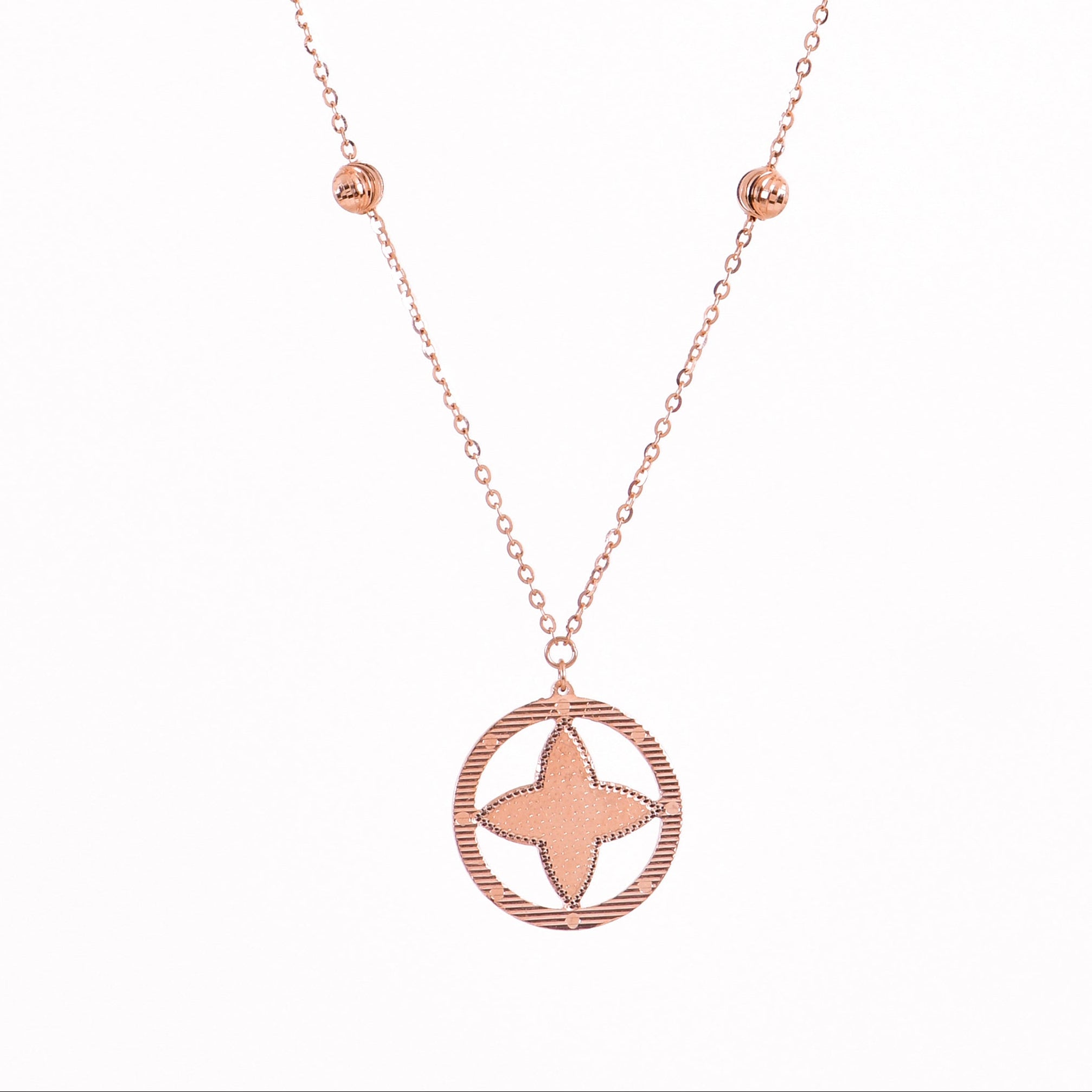 Rose gold necklace with star pendant on a white background