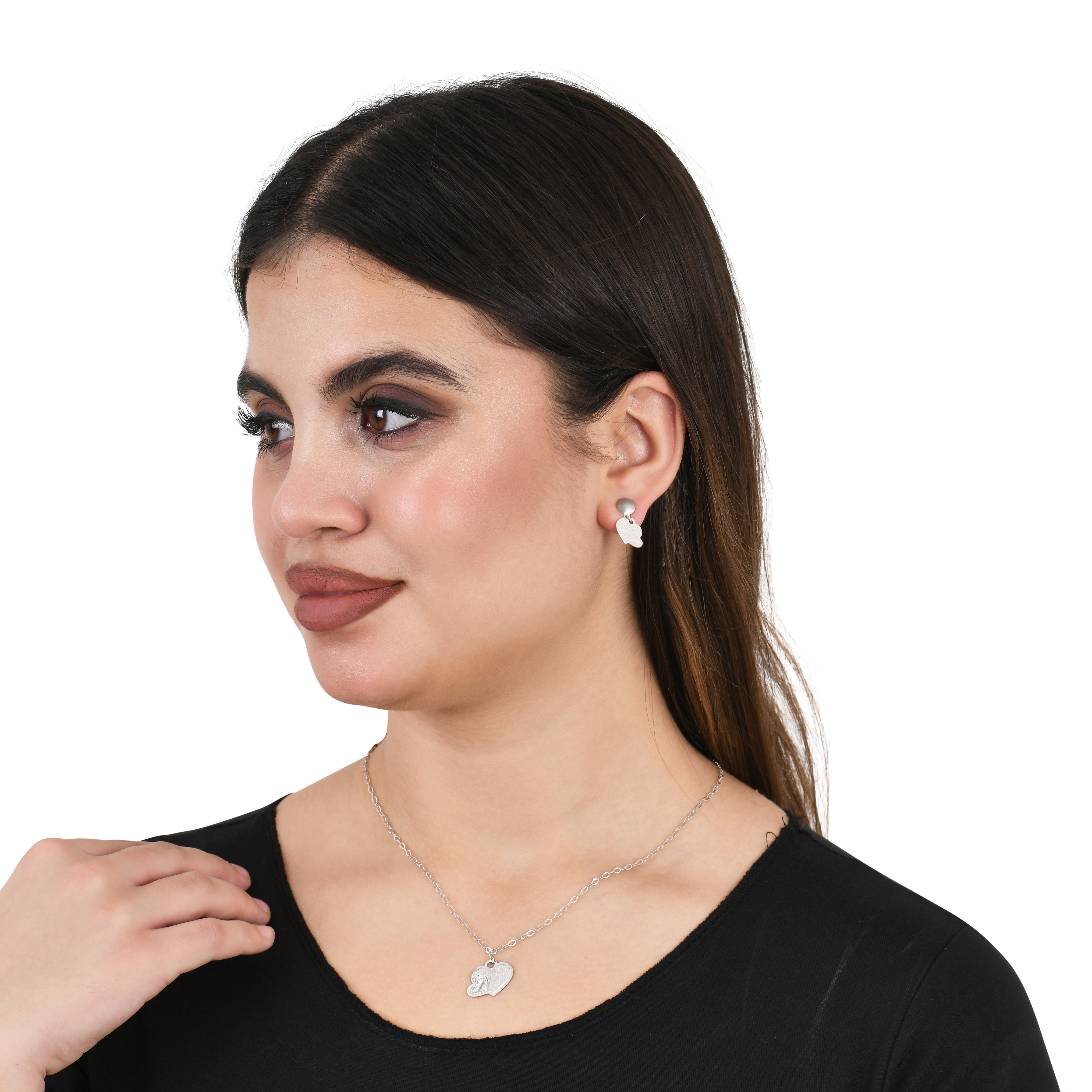 Woman wearing a silver necklace and earrings on a white background
