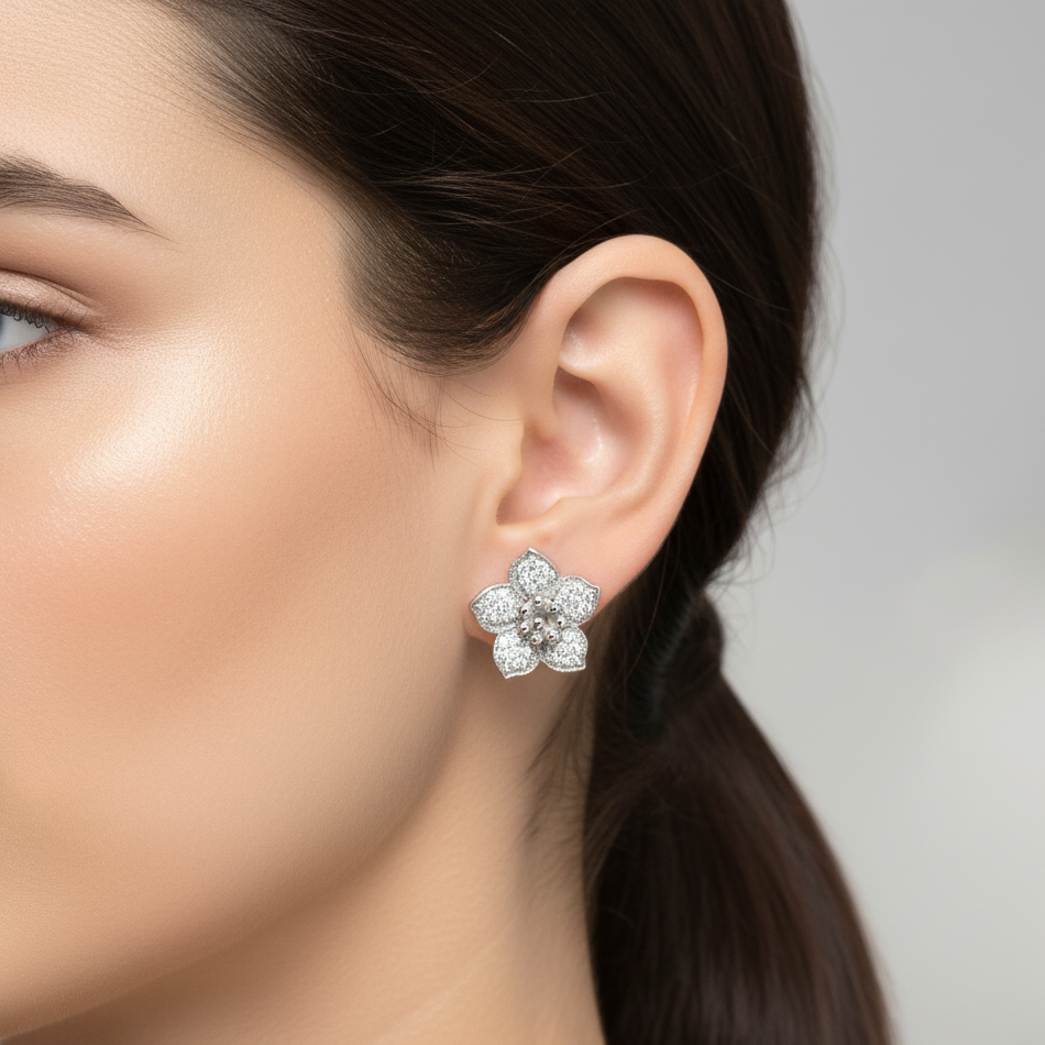 Close-up of a woman wearing a floral diamond earring against a neutral background