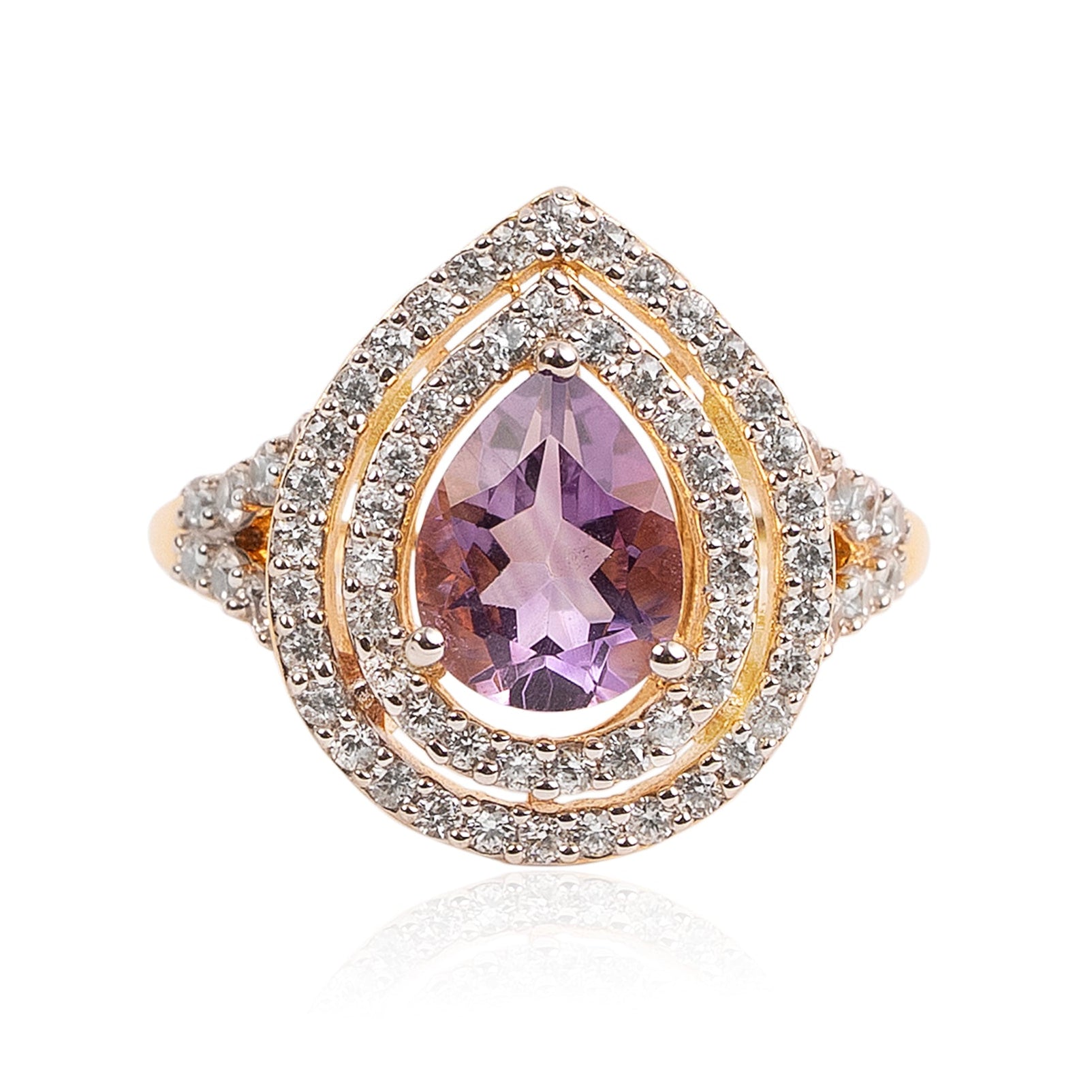 Gold ring with a purple teardrop-shaped gemstone on a white background