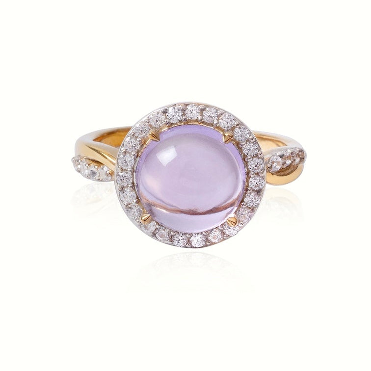 Ring with a purple gemstone and gold band on a white background
