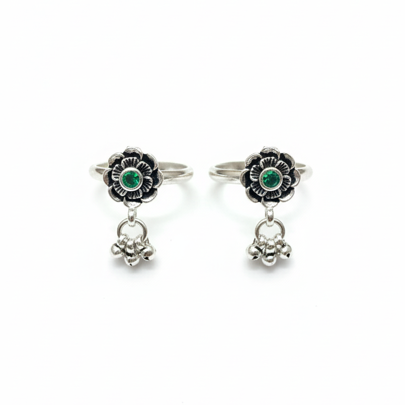 Pair of silver earrings with green gemstones on a white background