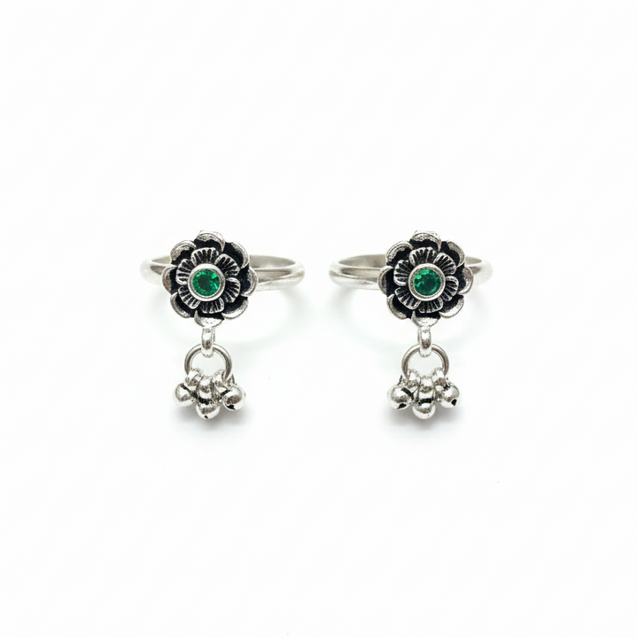 Pair of silver earrings with green gemstones on a white background