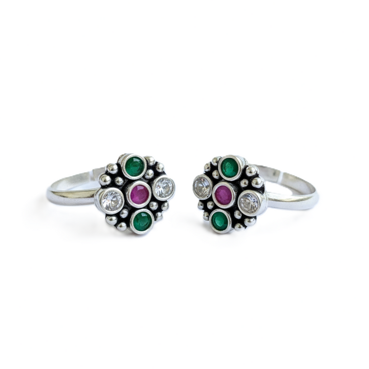 Two silver rings with gemstone accents on a white background
