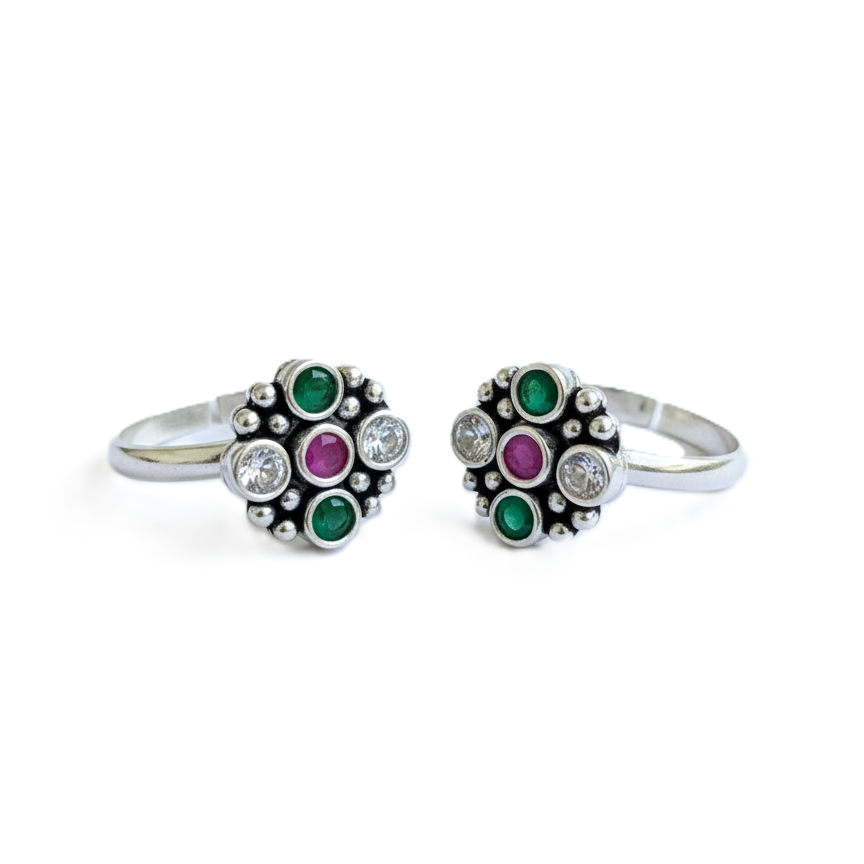 Two silver rings with gemstone accents on a white background