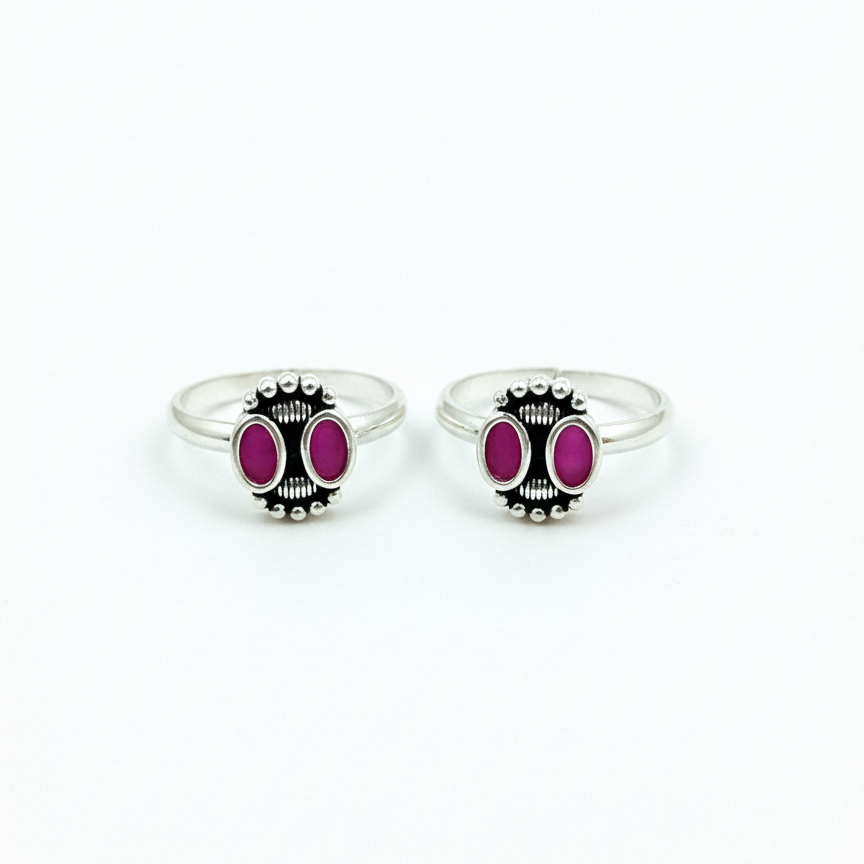 Two silver rings with pink gemstones on a white background