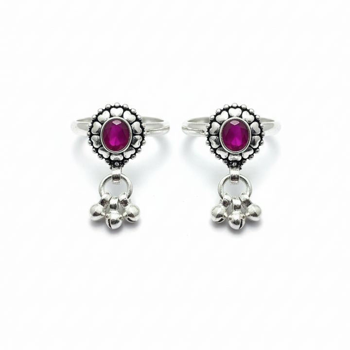 Pair of earrings with pink gemstones and silver accents on a white background