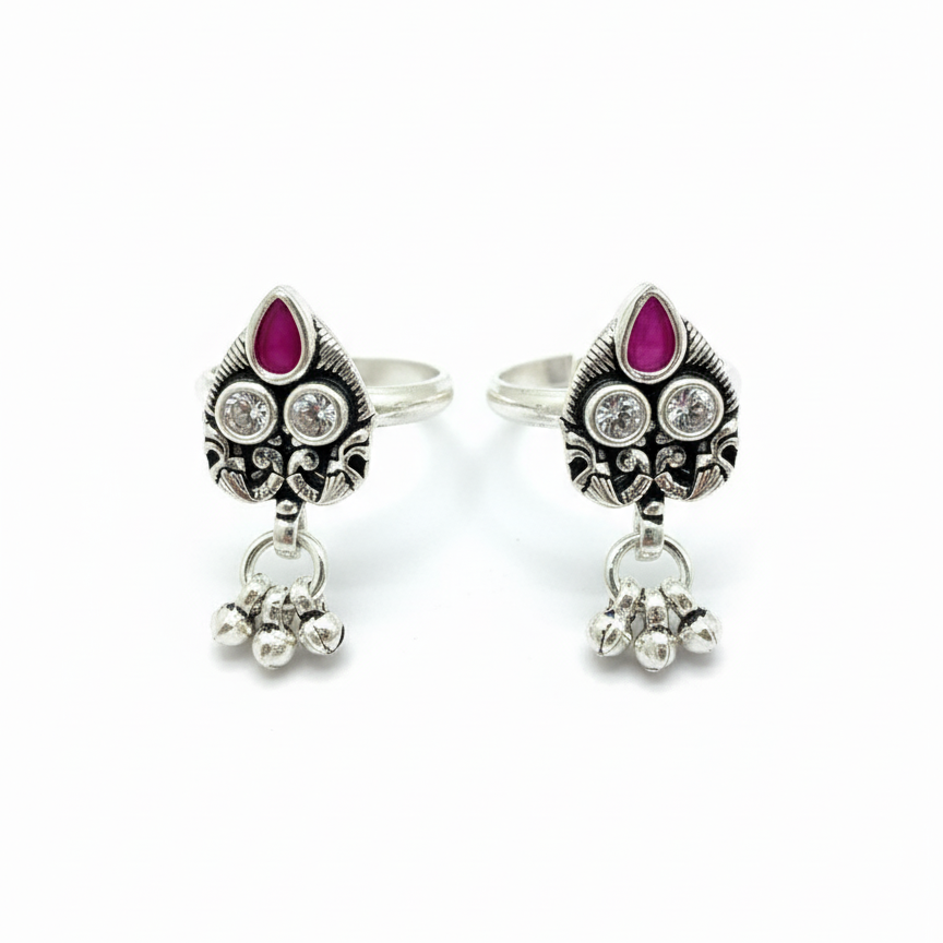 Pair of silver earrings with purple gemstones on a white background