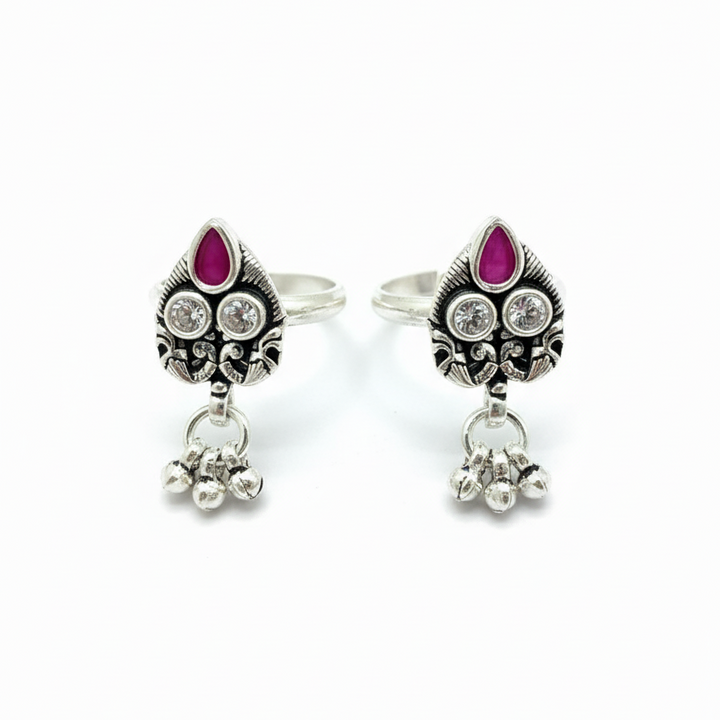 Pair of silver earrings with purple gemstones on a white background