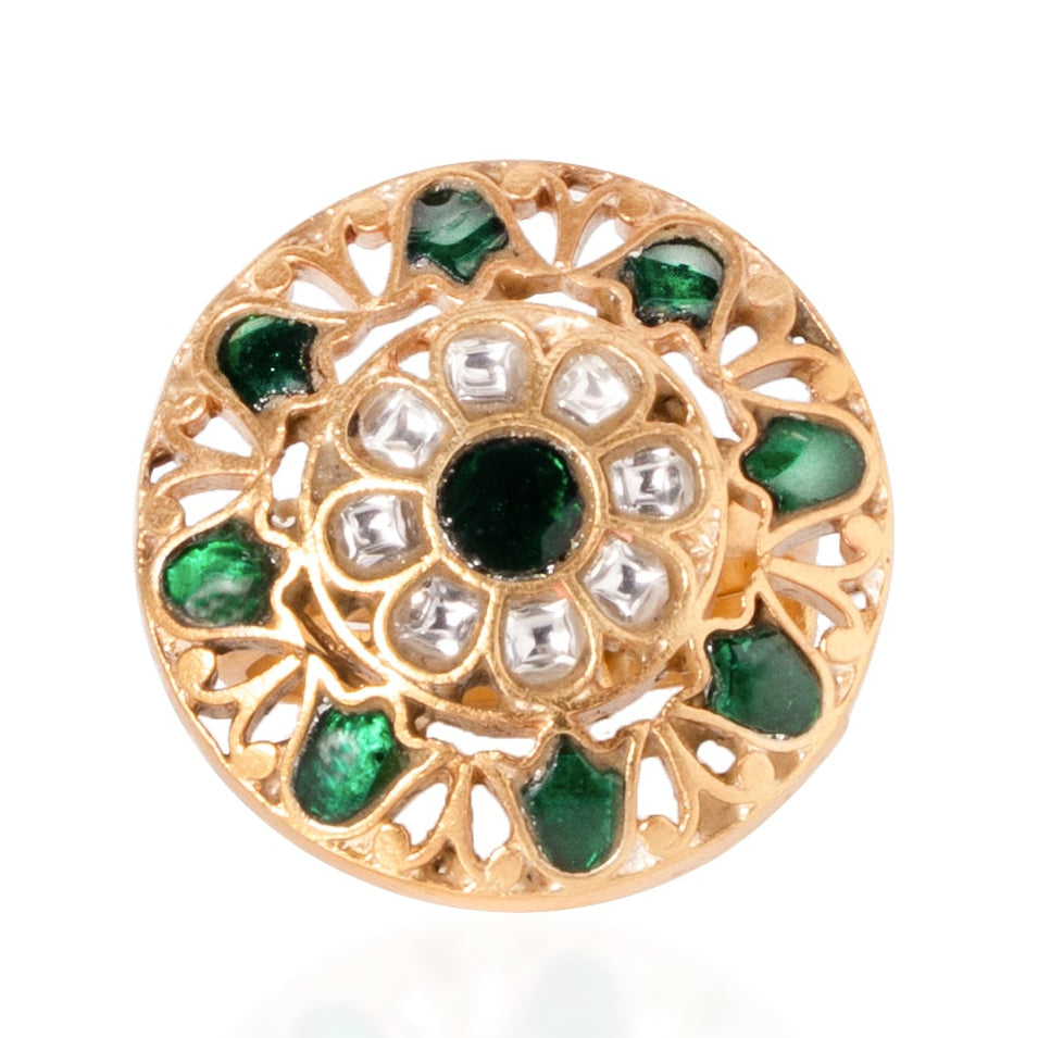 Gold circular charm with green gemstones on a white background