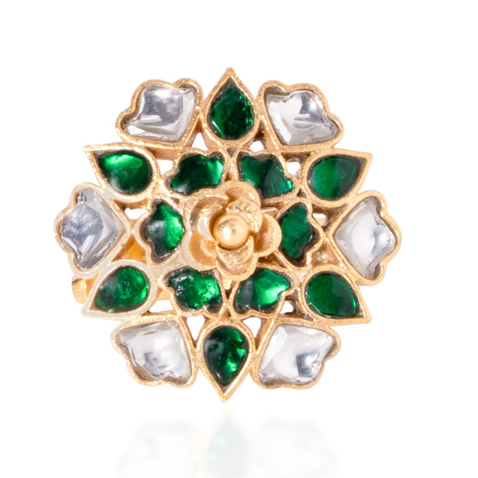 Gold ring with green and white gemstones on a white background