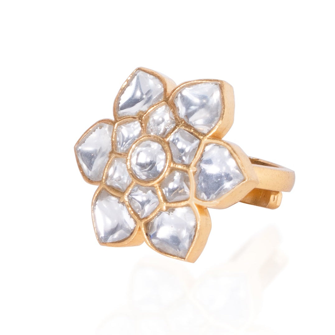 Gold ring with crystal embellishments on a white background
