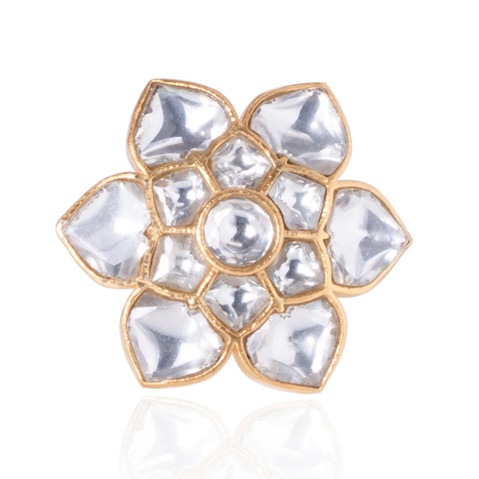 Gold ring with clear gemstones on a white background